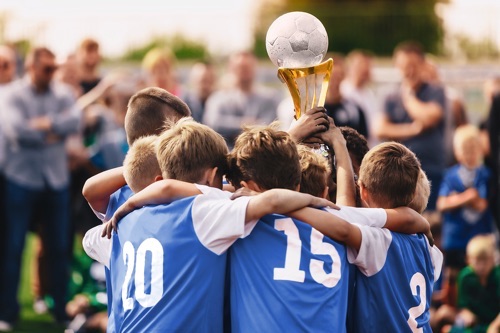Kids winning football trophy