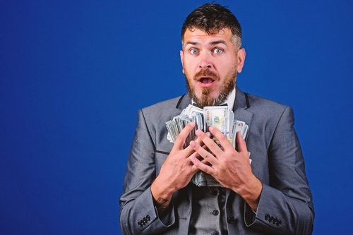 Man with stack of cash