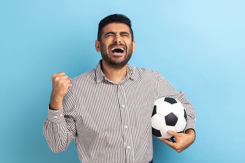 Man looking disappointed with a soccer ball