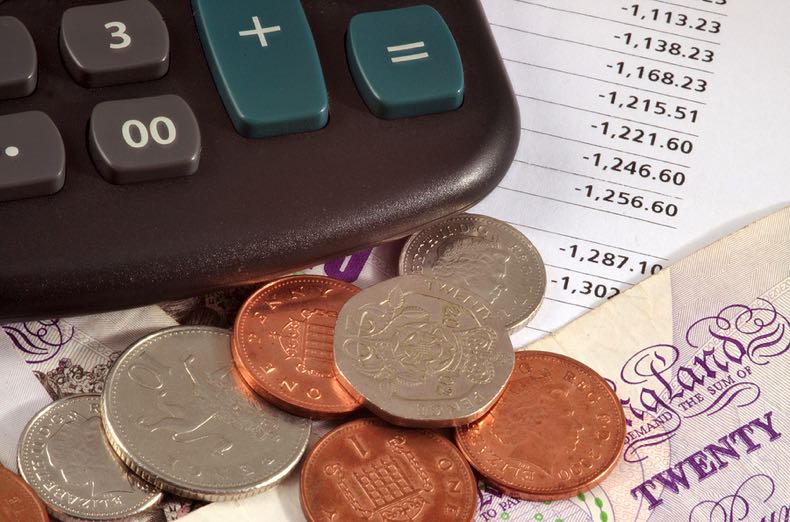 Calculator surrounded by British money