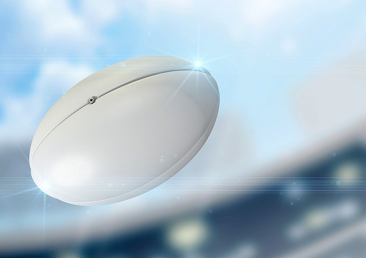 White Rugby Ball Flying Through Air