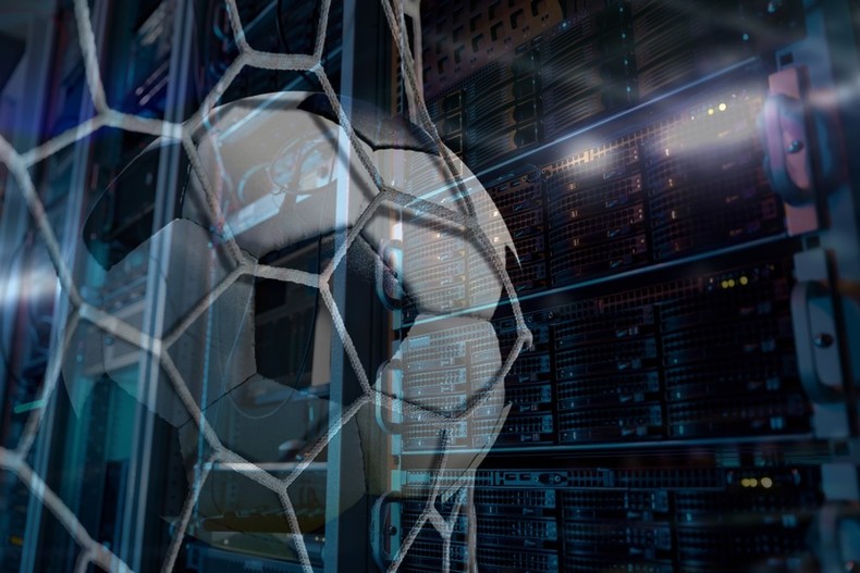 Football in Goal Net Against Computer Server Rack